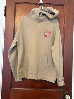 Unisex Beige Hoodie with Patch Logo From of a Pub in Dundalk Ireland